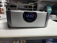 Front view showing Emerson Research branding, LED time display and speaker grille