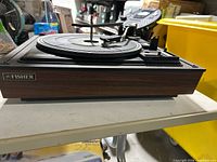 Front side view showing Fisher logo and wood-grain base