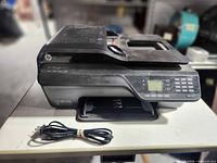 Front and top view of HP Officejet 4622 printer with power cord