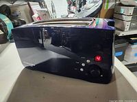 Front and side view of dark blue KitchenAid toaster showing control panel and digital display