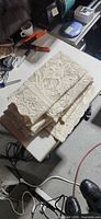 Stacked folded ivory lace panels on table