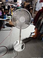 Front view of Lasko pedestal fan showing grille and base