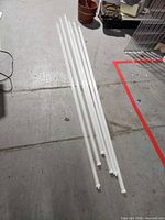 Six clear LED tube bulbs laid on floor showing full length and quantity