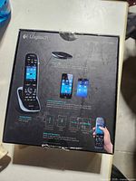 Front of box showing Logitech Harmony Ultimate remote and hub