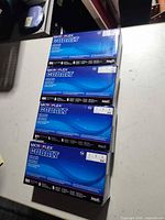 Stack of four sealed Microflex Cobalt glove boxes on countertop