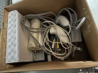 Wii console, two Wii Remotes, sensor bar and cables in box
