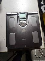 Top view of Omron HBF-514C scale showing platform, display and metallic contact pads