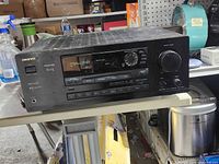 Front view of Onkyo receiver showing display, controls and volume knob