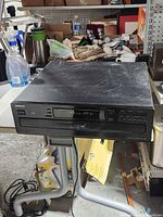 Front view of Onkyo multi-disc CD player showing display, controls, closed tray