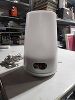 Front view showing cylindrical lamp body, LED time display, attached power cord