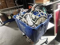Full tote showing assortment of power strips and surge protectors