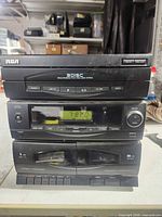Front view of stacked RCA 3-disc CD changer, tuner, cassette deck