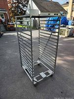 Full view of metal rolling rack front angle showing open frame and slotted rails