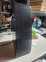 Front left side view showing curved grille and power cord