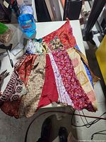 Blouse and pants laid flat showing overall patchwork design