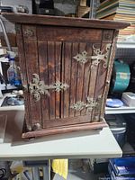 Front view showing plank door and iron hinges