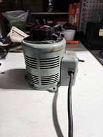 Side view of autotransformer showing vented cylindrical housing and attached control box with power cord