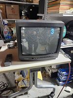 Front view of Sylvania CRT TV powered on displaying static