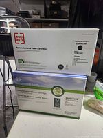 Two toner cartridge boxes, TRU RED and Sustainable Earth brands