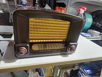 Front view showing grille, dial, knobs, General Electric branding