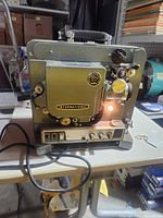 Front view showing International logo, lens, control panel, attached cord