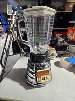 Full view of Osterizer Imperial blender with glass jar and lid on tabletop