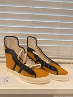 Side view pair of mustard yellow Converse Phil Esposito high-tops