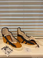 Pair of mustard canvas Converse Phil Esposito shoes with laces, leaflet visible, label card 75