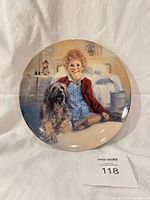 Front view showing illustration of Annie and Sandy on plate