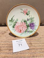 Front of floral hand-painted plate on stand