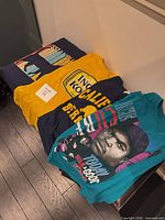 All four graphic t-shirts folded and displayed