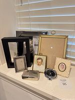 Group shot showing all frames, clock and metal box