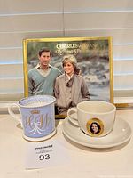 Group shot with both cups, saucer and book