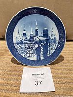 Front view of plate on stand showing full scene and date