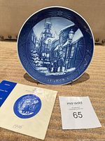 Front view of Royal Copenhagen 1996 Christmas plate with booklet and lot tag