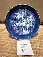 Front view of Royal Copenhagen 2003 Julegaven plate on stand