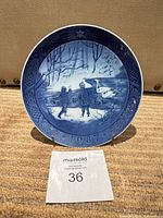 Front view of Royal Copenhagen Winterbirds plate on stand