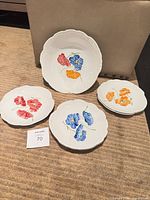 Six-piece porcelain set with floral decoration displayed on surface