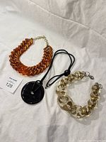 Group shot of all three necklaces laid flat