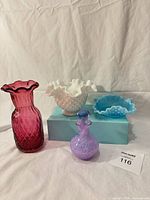 Front view of all four glass pieces showing colors, patterns and overall condition