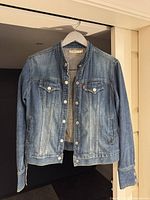 Front view of Levi's Red Tab denim jacket on hanger showing full garment and wash