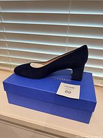 Left side view of navy suede pump on box
