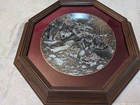 Front view showing framed plate with wolf imagery