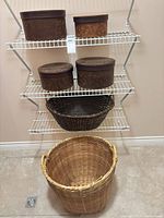 All six items on shelving: four hat boxes, dark shelf basket, light laundry basket
