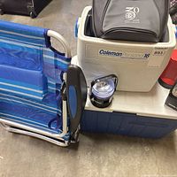 Group view of chair, coolers, soft bag and lantern