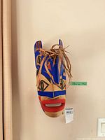 Front view of carved painted wooden mask