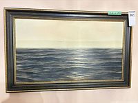 Front view of framed seascape painting