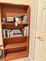 Front view of bookcase with contents on shelves