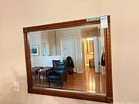 Front view of wood-framed horizontal mirror on wall