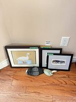 Group shot of three framed prints and two sculptures